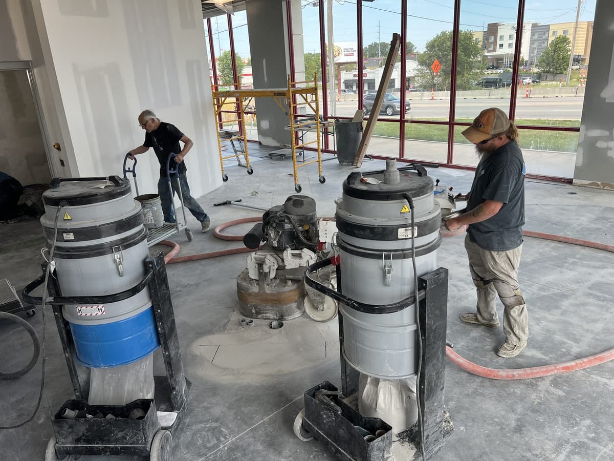 Victory Cleaning operators running planetary grinders with dust extraction